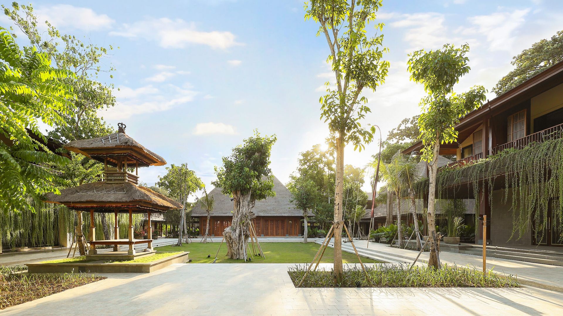 A quiet courtyard at Andaz Bali, wrapped around mature trees and traditional red brick walls