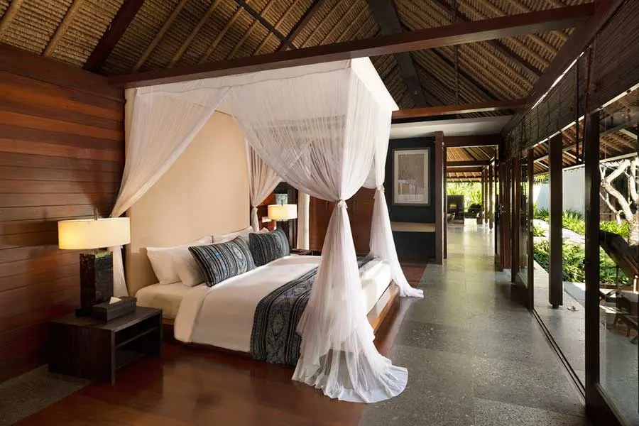 A canopied bed inside a villa at Kayumanis Jimbaran